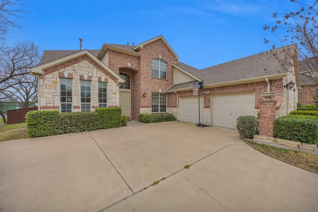 traditional home with an attached garage, a shingled roof, concrete driveway, and brick siding