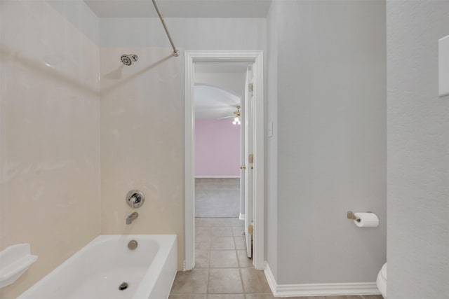 full bath featuring shower / bathtub combination, toilet, a ceiling fan, tile patterned flooring, and baseboards