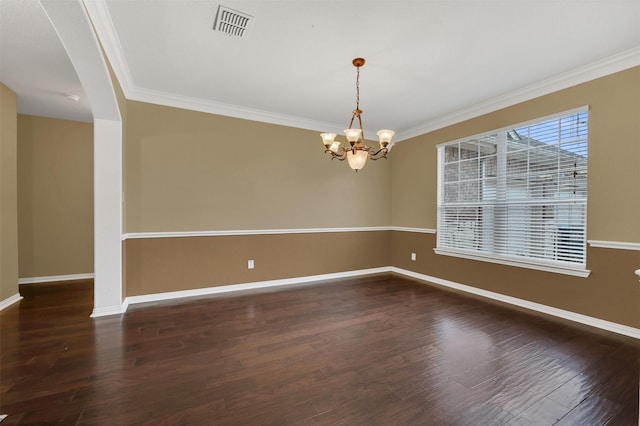 spare room with baseboards, visible vents, wood finished floors, and ornamental molding