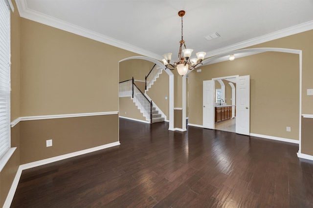 unfurnished room with arched walkways, ornamental molding, stairway, and wood finished floors