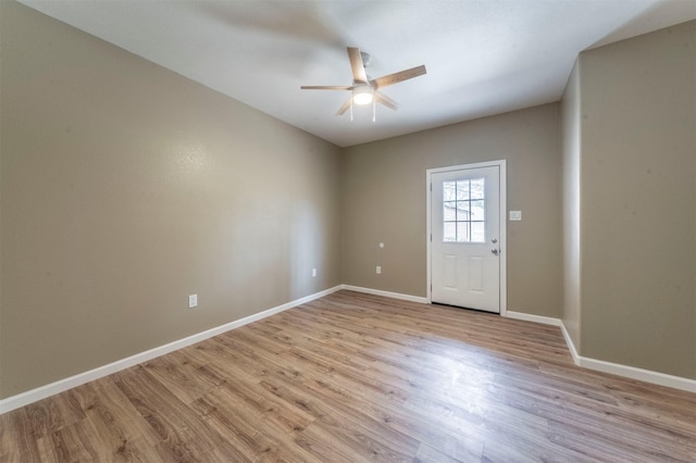 entrance foyer with baseboards, ceiling fan, and light wood-style floors