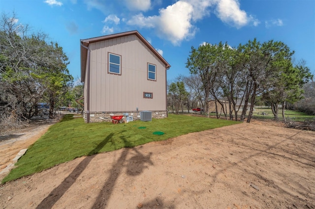 rear view of house with a yard and central air condition unit