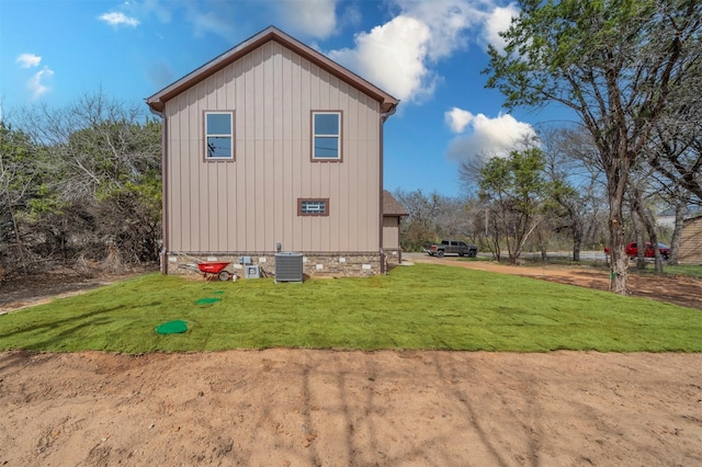 view of property exterior with a lawn and central air condition unit