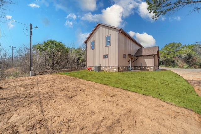 view of property exterior featuring a lawn and central air condition unit