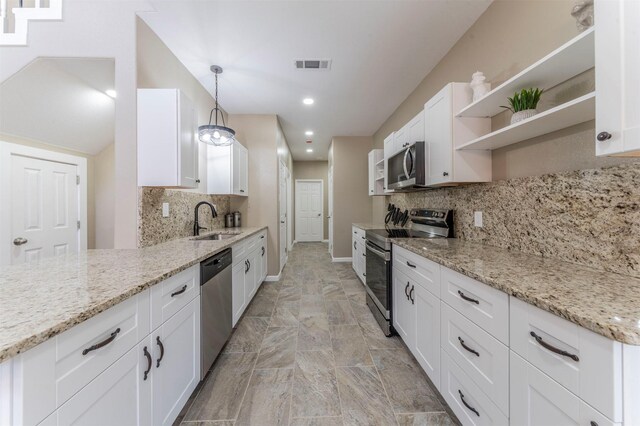 kitchen with visible vents, white cabinets, stainless steel appliances, open shelves, and a sink