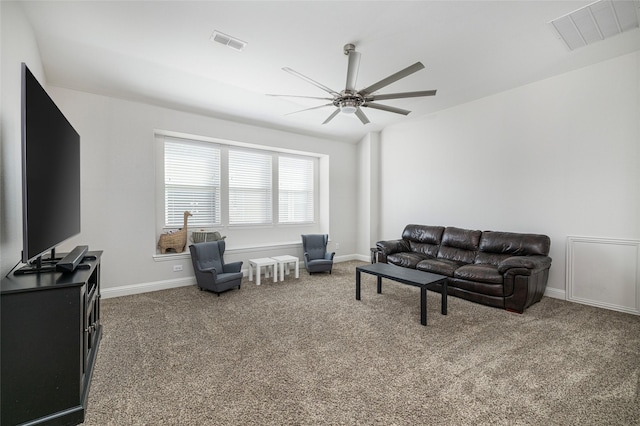 carpeted living room featuring baseboards, visible vents, and a ceiling fan