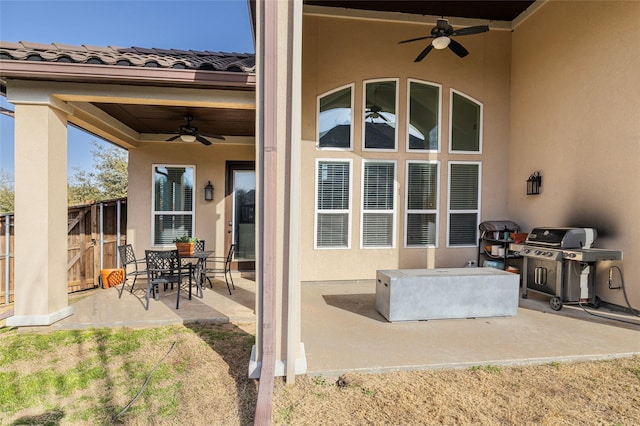 view of patio with fence, grilling area, and a ceiling fan