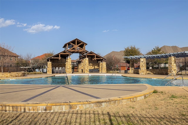 community pool with a patio, fence, and a pergola