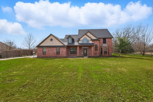 view of front of property with brick siding and a front lawn