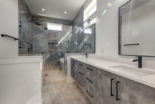 bathroom with double vanity, a sink, and a marble finish shower