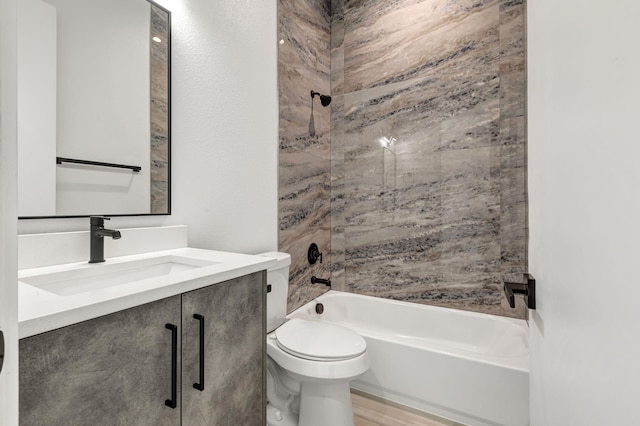 bathroom featuring shower / bathing tub combination, vanity, and toilet