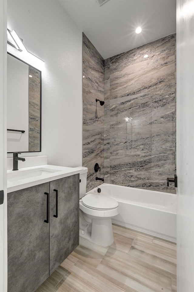 bathroom with visible vents, shower / bathing tub combination, vanity, and toilet