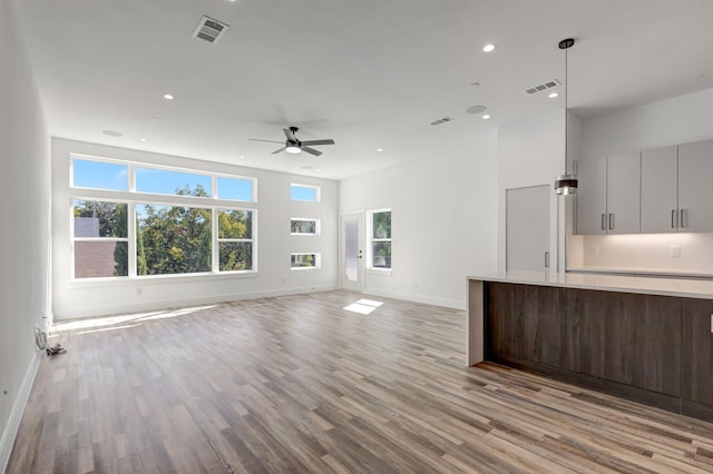 unfurnished living room featuring light wood finished floors, recessed lighting, visible vents, and a ceiling fan