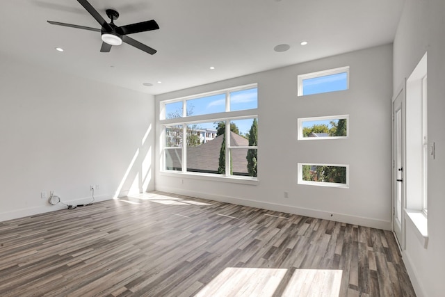 spare room with recessed lighting, ceiling fan, baseboards, and wood finished floors