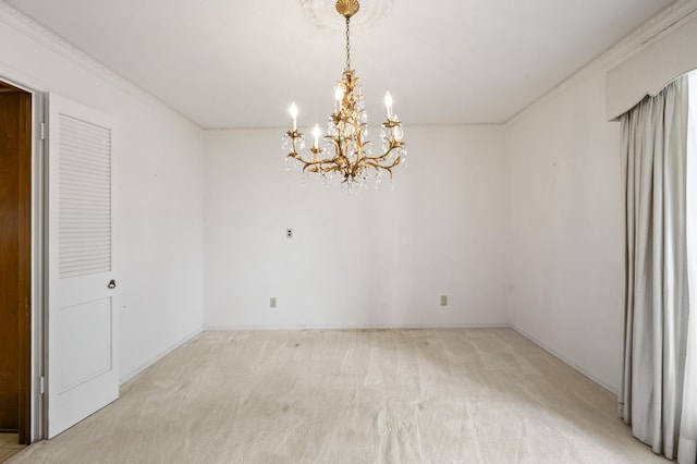 spare room featuring ornamental molding, a notable chandelier, and light colored carpet