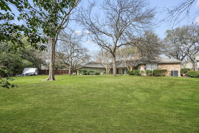 view of yard featuring cooling unit and fence