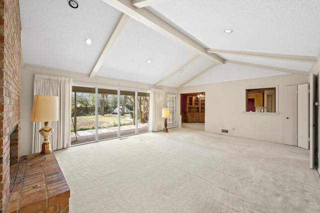 unfurnished living room with vaulted ceiling with beams, a textured ceiling, a brick fireplace, and carpet