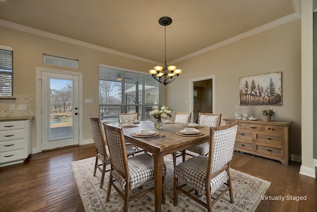 dining area featuring ornamental molding, dark wood-style floors, baseboards, and a chandelier