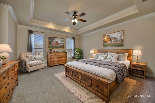 bedroom featuring light colored carpet, a tray ceiling, and ornamental molding