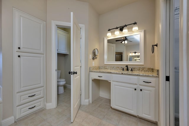 bathroom with tile patterned floors, toilet, vanity, and baseboards