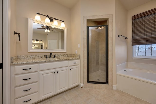 bathroom featuring tile patterned flooring, a garden tub, a stall shower, vanity, and a ceiling fan