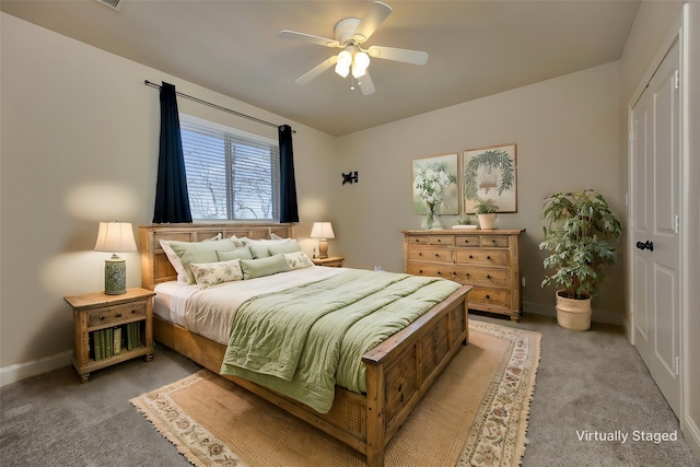 bedroom featuring light colored carpet, a ceiling fan, and baseboards