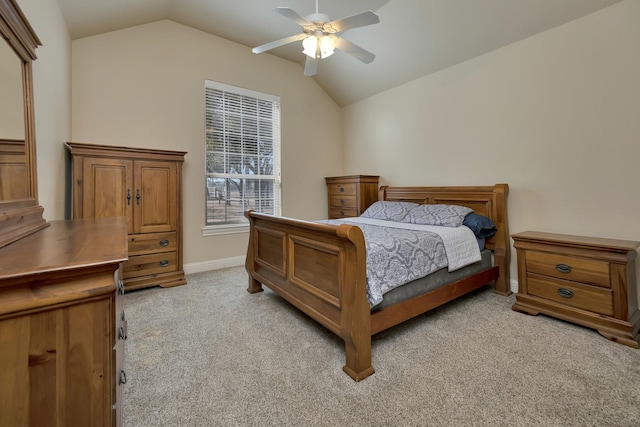 bedroom with baseboards, lofted ceiling, light carpet, and a ceiling fan