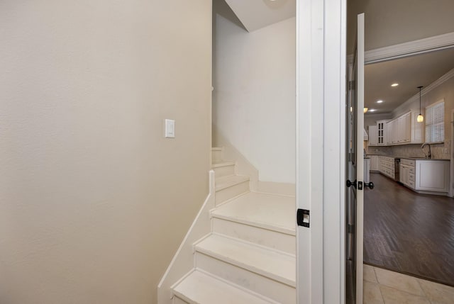 stairs featuring tile patterned flooring, recessed lighting, and ornamental molding