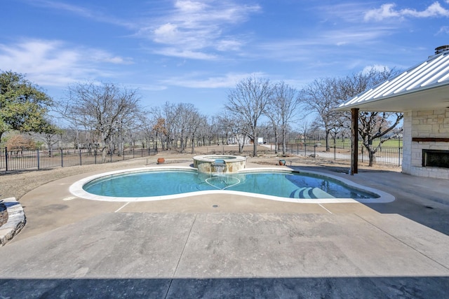 view of swimming pool featuring a patio, fence, and a pool with connected hot tub