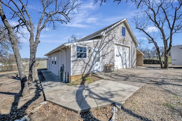 view of side of property with a garage