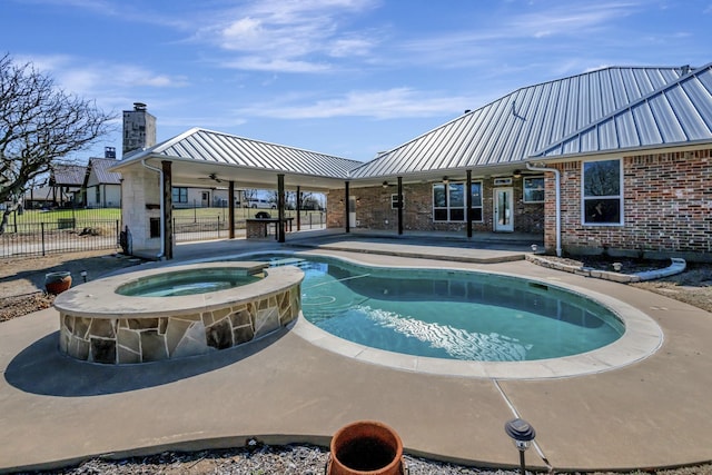 view of swimming pool featuring a ceiling fan, a patio, fence, and a pool with connected hot tub