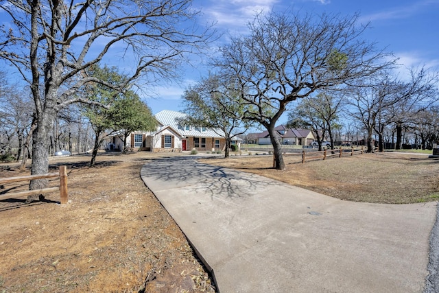 view of front of home featuring metal roof and driveway