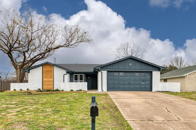 view of front of house with an attached garage, brick siding, fence, concrete driveway, and a front yard