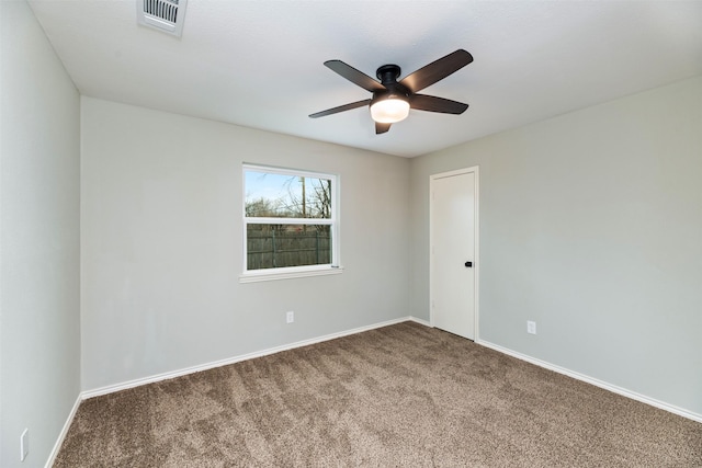 empty room with a ceiling fan, carpet, visible vents, and baseboards