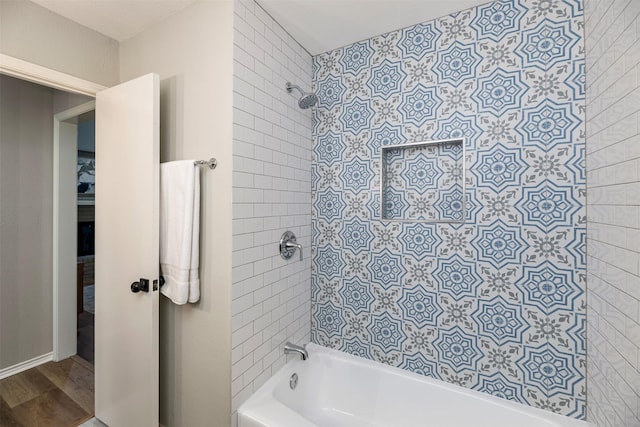 bathroom featuring shower / tub combination and wood finished floors