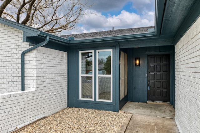 property entrance with brick siding