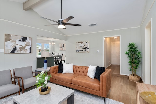 living area featuring lofted ceiling with beams, visible vents, wood finished floors, and ceiling fan with notable chandelier