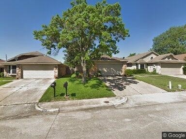 single story home with an attached garage, concrete driveway, and a front lawn