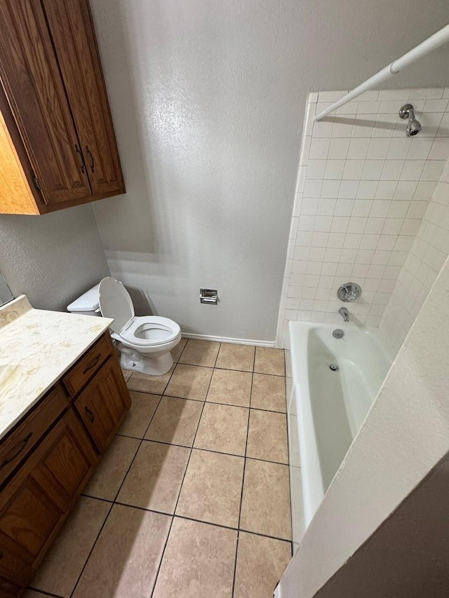 full bath featuring vanity, baseboards, shower / tub combination, tile patterned floors, and toilet