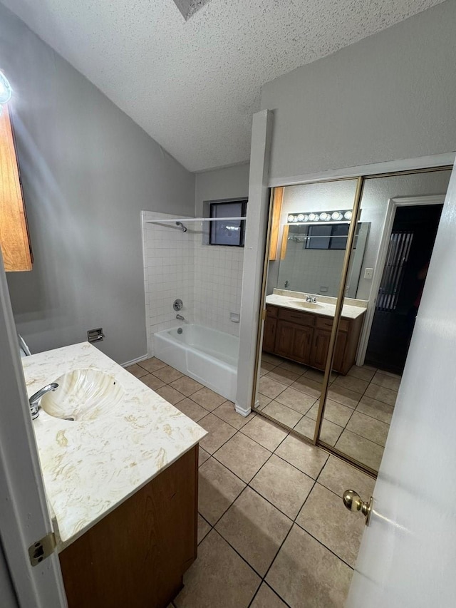 bathroom with tile patterned floors, shower / bathing tub combination, a textured ceiling, and vanity