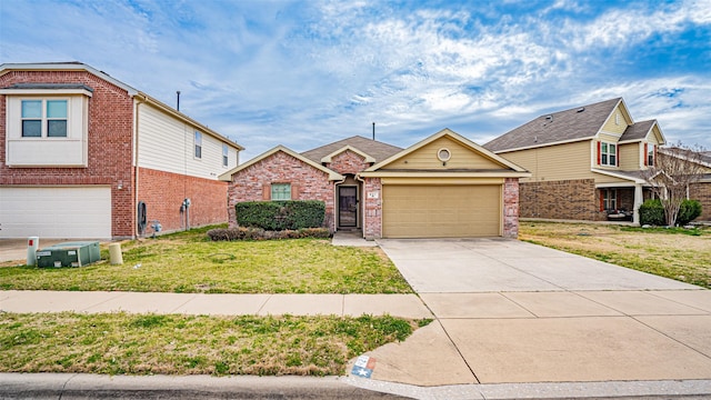 view of front of home featuring a garage, brick siding, driveway, and a front lawn