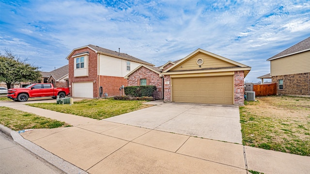 view of front of house featuring driveway, fence, a front lawn, central AC, and brick siding