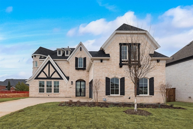 view of front of property featuring brick siding and a front yard