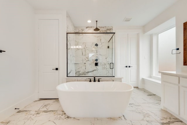 bathroom featuring a marble finish shower, marble finish floor, vanity, a freestanding tub, and recessed lighting