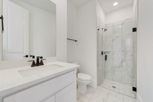 bathroom featuring marble finish floor, vanity, a marble finish shower, and toilet