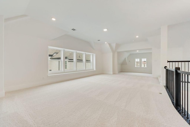 spare room featuring lofted ceiling, recessed lighting, and light colored carpet