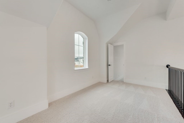 bonus room featuring light carpet, baseboards, and vaulted ceiling