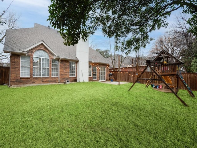 exterior space featuring a fenced backyard, a lawn, and a playground