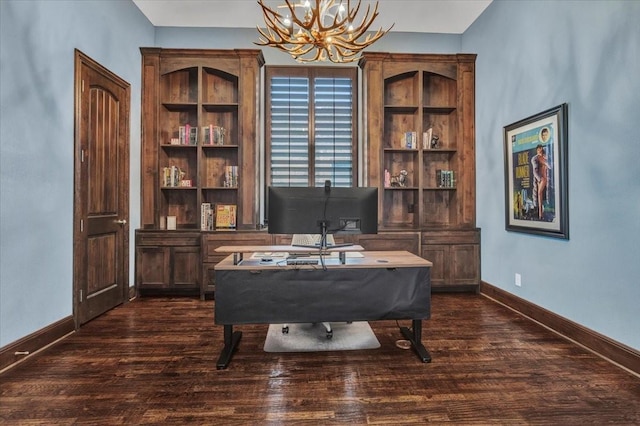 office area featuring dark wood-type flooring, baseboards, and an inviting chandelier