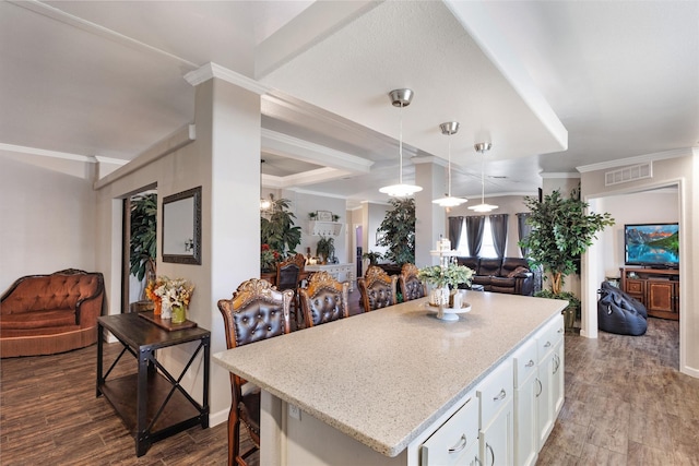 kitchen featuring white cabinets, visible vents, a center island, open floor plan, and dark wood finished floors